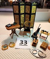 Photo of full set of vintage dollhouse accessories including room divider, table with adding machine, chair, upright vacuum, sewing machine, abacus, spice box, trays, butterfly pictures, and wall phone