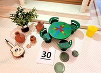 Full set of Mexican themed miniature furniture and accessories including table, chairs, pots, plates, guitar, and planter, all arranged on a light surface.