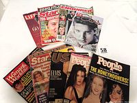Photo showing 11 assorted magazines featuring Elvis Presley covers and articles, displaying condition and variety of editions.
