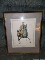 Framed antique lithograph print showing a man in military uniform riding a horse.
