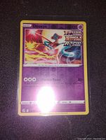 Photo of the Deoxys Fusion Strike Holo Pokémon card showing front side with character artwork and attack information.