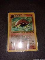 Photo of Kabuto Pokemon card from the Fossil set in protective sleeve.
