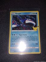 Front of Kyogre holographic foil Pokémon card showing artwork, stats, and attacks Aqua Storm, Surf.