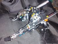 Front and side view of the completed Lego Batman Batcrawler showing the vehicle's tracked arms, cockpit, and color details.