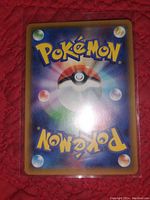 Reverse side of a Pokémon card showing the standard Poké Ball design with a holographic glow on the surface.
