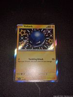 Photo of a shiny Voltorb Pokemon card with holographic foil background and star shapes, card is 3 inches tall and in mint condition.