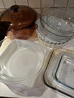 Overall view of various Pyrex glass baking, mixing, and cooking items arranged on a kitchen counter