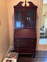 Front view of the full secretary desk showing upper glass doors, drop-front desk and lower drawers