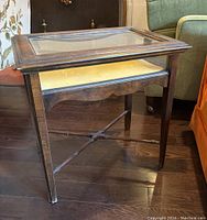 Photo of the wood table showing full side view including leg details and crossbars.