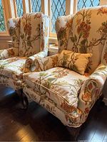 Pair of wingback chairs side by side near window