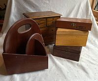 Wide shot showing all wooden boxes including cutlery holder, jewelry box with drawers, light and dark wooden boxes stacked
