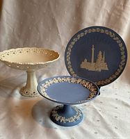 Two Wedgwood compotes, white pierced lace edge and blue Jasperware with classical relief decoration