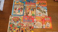 Overview photo showing all 7 Archie Comics arranged on table.