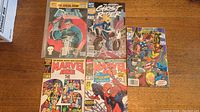 All five Marvel comic books laid out on table, showing front covers including The Punisher, Ghost Rider, Avengers, Marvel Age 25th Anniversary, and Spider-Man issues.