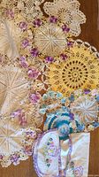 Lot of various crocheted doilies in multiple colors and floral designs