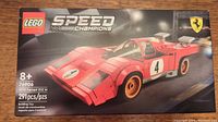 Front view of sealed Lego Speed Champions set 76906 box showing the red Ferrari 512 M race car model with racing decals and Ferrari logo.