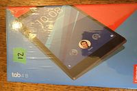 Front angled view of the sealed Lenovo Tab 4 8 tablet box showing the product image and branding in original packaging.