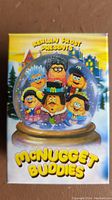 Photo of the McNugget Buddies box showing colorful snow globe with six characters illustrated
