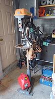 Front view of Ridgid drill press on stand with cord, chuck and work table visible