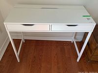 Front view showing two drawers and laminate surface.