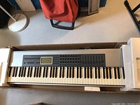 M-Audio Keystation Pro 88 keyboard in its original box, showing full length and control panel