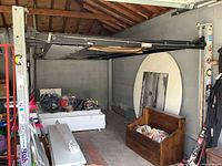 Assembled lift posts, crossbeams and supporting structure in a garage space.