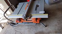 Top-down view of the Ridgid table saw on stand showing fence, tabletop and miter gauge