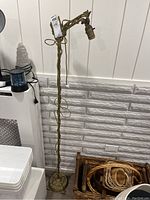 Full view of the vintage metal floor lamp without shade, showing twisted shaft and ornate base.