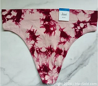Full front view of seamless ribbed thong in pink and dark red splash tie dye pattern with brand tag visible.