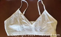 Front view of white Jenni women's light support bralette showing fabric and thin straps.