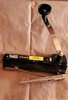 Klein Tools autoclamping cable cutter front view showing blade and handle.