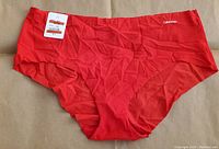 Front view of red Calvin Klein women's hipster panties, showing cut and Calvin Klein logo.
