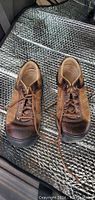 Front view of the men's brown nubuck style Keen shoes with laces, showing overall condition.