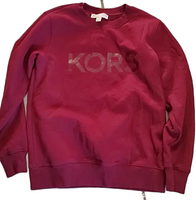 Front view of maroon Michael Kors sweatshirt with shiny KORS logo on chest in gently used condition.