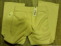 Front view of the white chenille shorts laid flat showing wide leg and elastic waistband with tags attached.