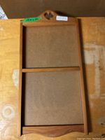 Full view of the wooden calendar frame showing its overall shape and two display sections.