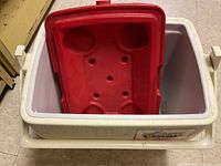 Top view showing inside of cooler with red tray inserted inside and cup holders.