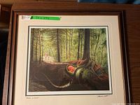Full view of framed artwork showing forest scene and green measurement sticker