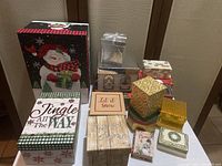 Full assortment of Christmas themed boxes displayed on the floor. Variety of sizes and designs, including a ceramic trinket box.