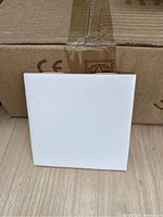 Front face showing smooth white glazed surface of the tile.