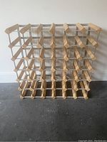 Front view of the wine rack showing the 6x6 grid structure with wooden slats and metal support, designed to store 36 bottles.