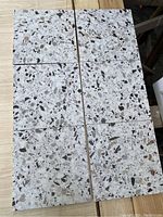 6 terrazzo print porcelain tiles arranged to show pattern and color detail