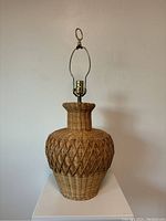 Full view of rattan lamp base showing the shape and woven pattern.