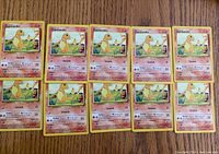 Photo showing 10 Charmander Base Set cards from 1999, with identical artwork and attacks Scratch and Ember.