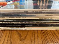 Close-up photo of the stacked vinyl albums' spines showing artist names and album titles, confirming jazz and easy listening genres.