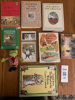Overview of the collection showing seven books, plush Toad doll, stamps, and cookbook on a wooden surface