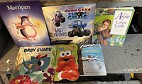 Photo showing seven assorted children's books with colorful illustrated covers including 'Marzipan', 'John Cena and Elbow Grease: Fast Friends', 'Anne of Green Gables', 'Baby Shark', and others.