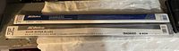 Photo of two ACDelco windshield wiper blades in original packaging, showing packaging detail and part number on one blade.