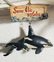 Photo of the ornament showing the 'Save the Whales' sign with orca whales suspended below it.