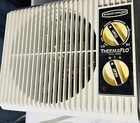 Front view of the ThermaFlo heater showing the white grill and control panel with temperature and heat adjustment dials.